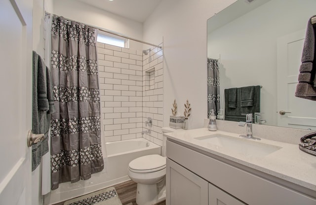 full bathroom featuring vanity, hardwood / wood-style floors, shower / tub combo with curtain, and toilet