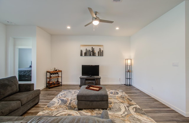 living room with ceiling fan and dark hardwood / wood-style floors