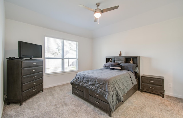 bedroom with ceiling fan, light colored carpet, and multiple windows