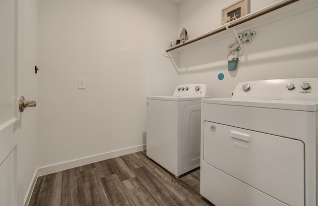 clothes washing area featuring dark hardwood / wood-style floors and independent washer and dryer