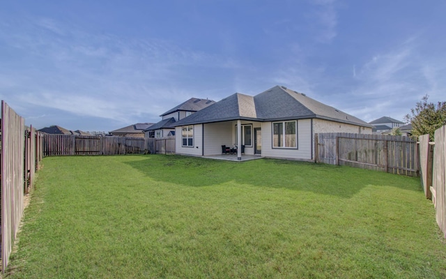 rear view of property with a patio area and a lawn