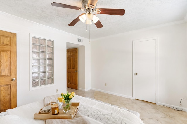 interior space featuring ornamental molding, light tile patterned floors, ceiling fan, and a textured ceiling