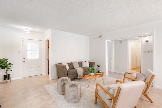 living room with light tile patterned floors, ornamental molding, and a textured ceiling