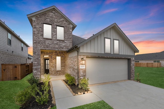 view of front of home with a yard and a garage