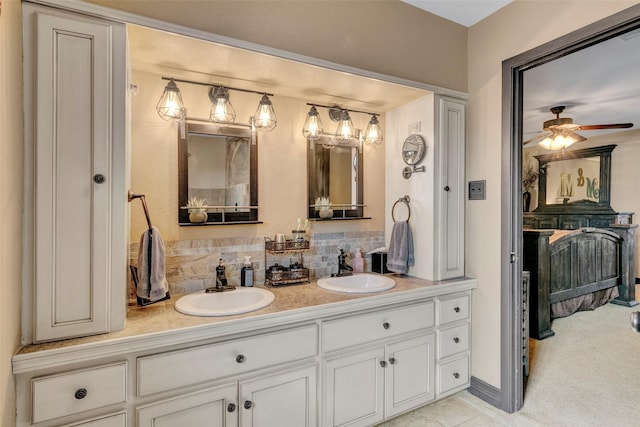 bathroom featuring tile patterned flooring, vanity, ceiling fan, and decorative backsplash