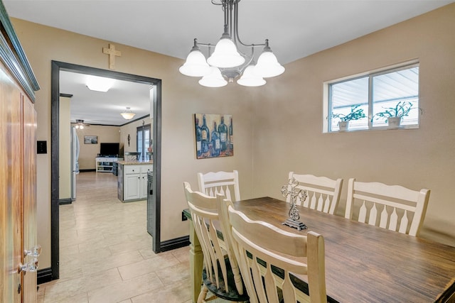 tiled dining space with ceiling fan with notable chandelier