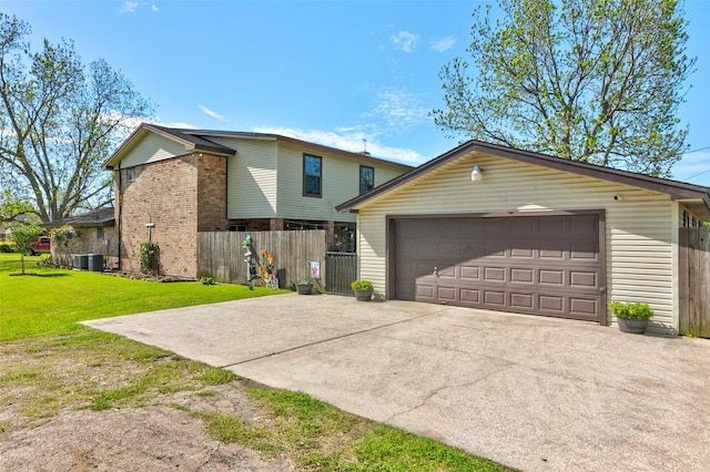 view of front of home featuring a garage, an outdoor structure, and a front lawn