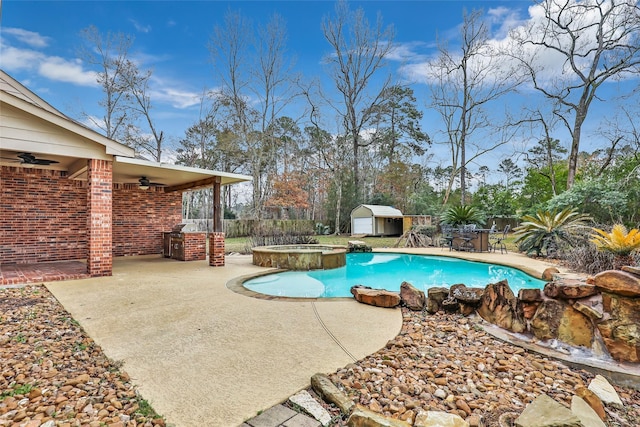 view of pool featuring a patio area, a storage unit, ceiling fan, and an in ground hot tub