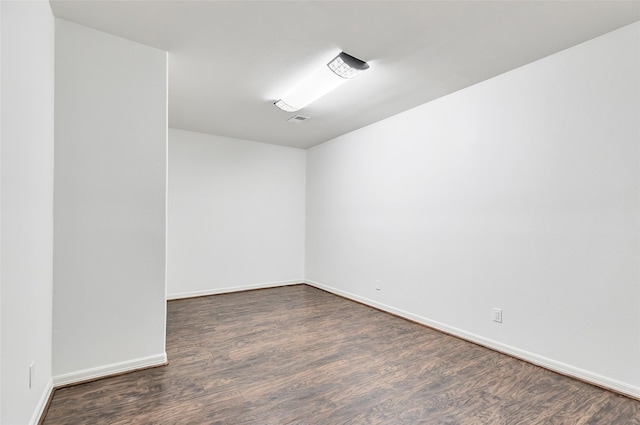 empty room featuring dark wood-type flooring