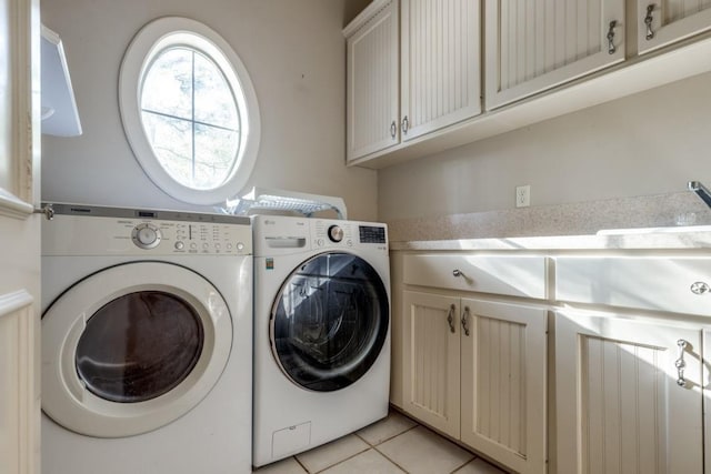 laundry room featuring cabinets, sink, light tile patterned floors, and washer and clothes dryer