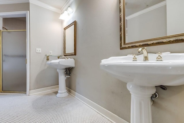 bathroom featuring crown molding, sink, and a shower