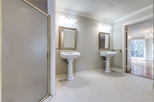 36111 Post Oak Cir, Magnolia, TX 77355 - bathroom featuring a shower stall, a textured ceiling, ornamental molding, and a chandelier