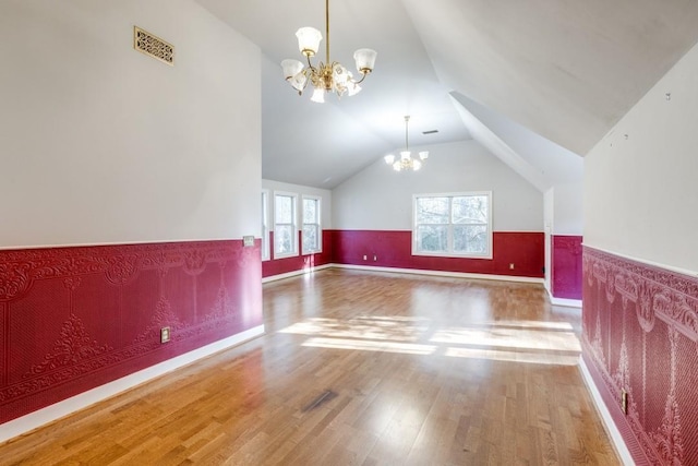 36111 Post Oak Cir, Magnolia, TX 77355 - bonus room with a chandelier, vaulted ceiling, a wainscoted wall, and wood finished floors