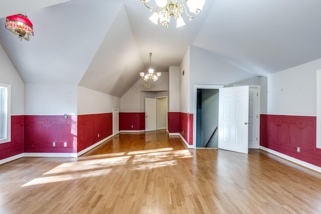 36111 Post Oak Cir, Magnolia, TX 77355 - bonus room featuring a chandelier, vaulted ceiling, wood finished floors, and a wainscoted wall