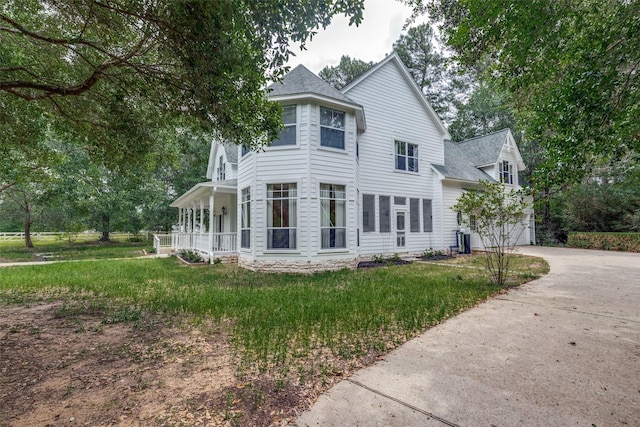 36111 Post Oak Cir, Magnolia, TX 77355 - view of front of property with a porch, a garage, concrete driveway, and a shingled roof