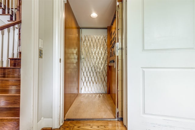 36111 Post Oak Cir, Magnolia, TX 77355 - hall featuring stairs, elevator, and wood finished floors