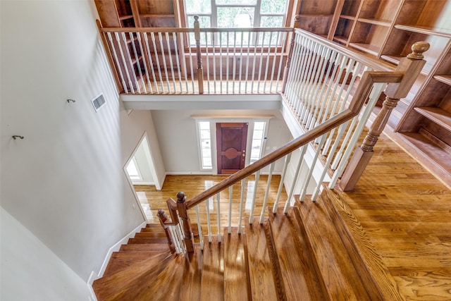 36111 Post Oak Cir, Magnolia, TX 77355 - stairway featuring a high ceiling and wood finished floors