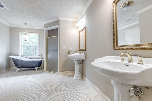 36111 Post Oak Cir, Magnolia, TX 77355 - bathroom featuring a freestanding bath, a shower stall, ornamental molding, and a textured ceiling