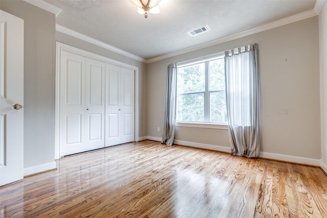 36111 Post Oak Cir, Magnolia, TX 77355 - unfurnished bedroom with wood finished floors, ornamental molding, and a closet