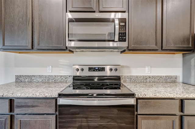 kitchen with stainless steel appliances and dark brown cabinetry