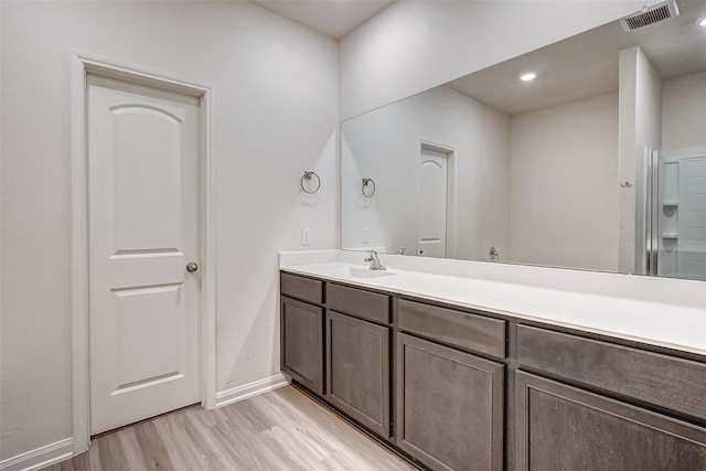 bathroom with vanity and hardwood / wood-style floors