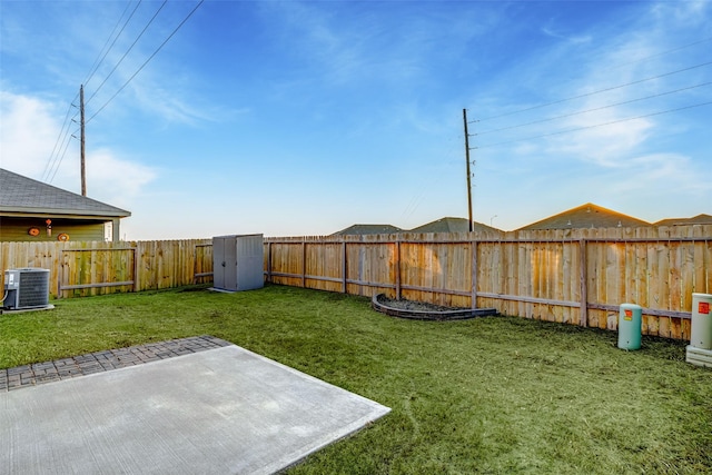 view of yard featuring central AC unit and a patio area