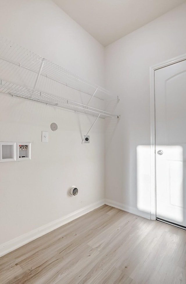 washroom with washer hookup, light hardwood / wood-style floors, and electric dryer hookup