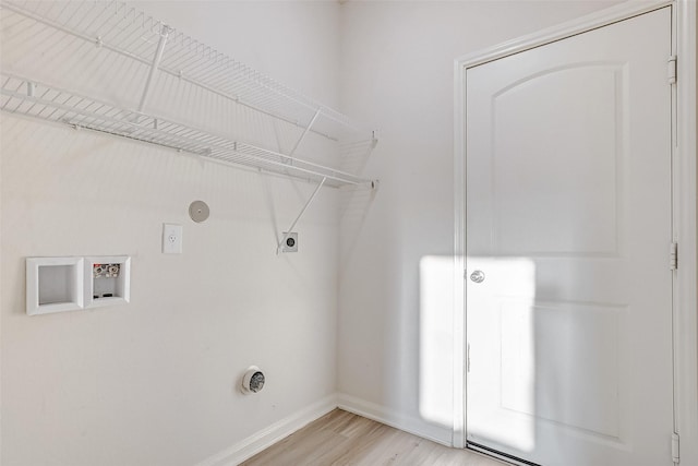 clothes washing area with washer hookup, hookup for an electric dryer, hookup for a gas dryer, and light hardwood / wood-style flooring