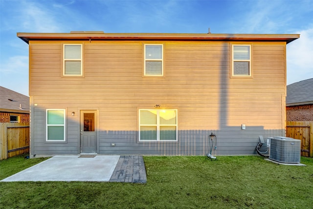 back of property featuring central AC, a yard, and a patio area