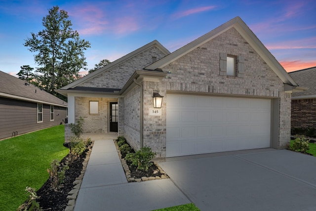 view of front of property featuring a garage and a yard