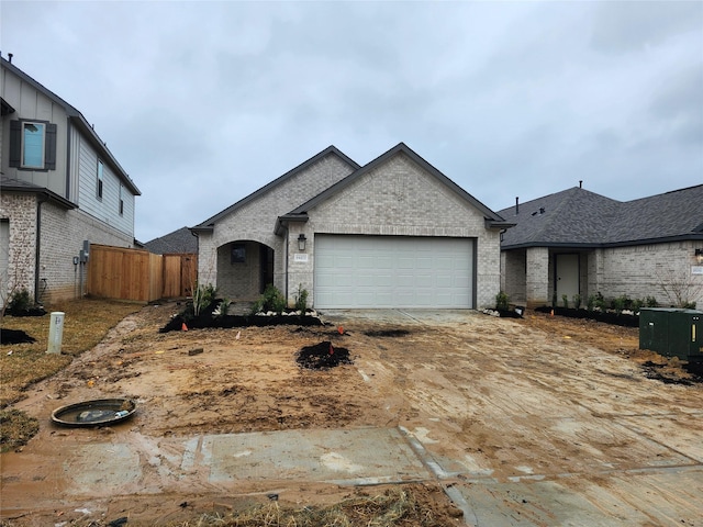 view of front of property featuring a garage and central AC