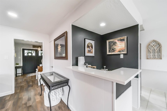 interior space with baseboards, wood finished floors, and recessed lighting