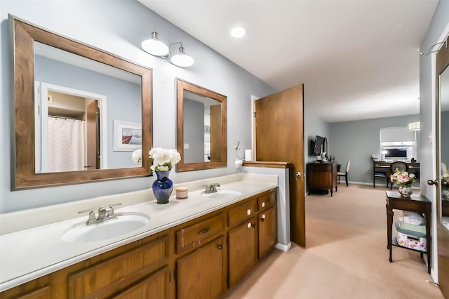 full bathroom with double vanity and a sink