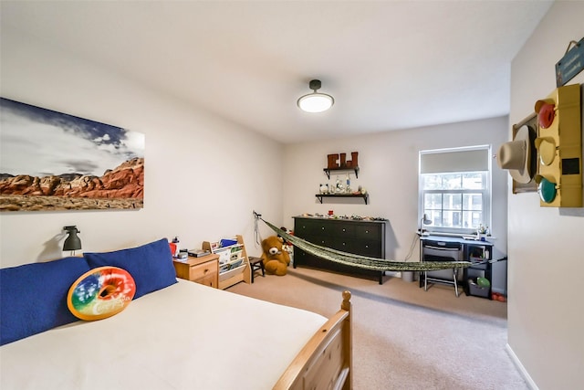 carpeted bedroom featuring baseboards