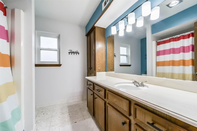 full bathroom with a shower with curtain, vanity, and baseboards