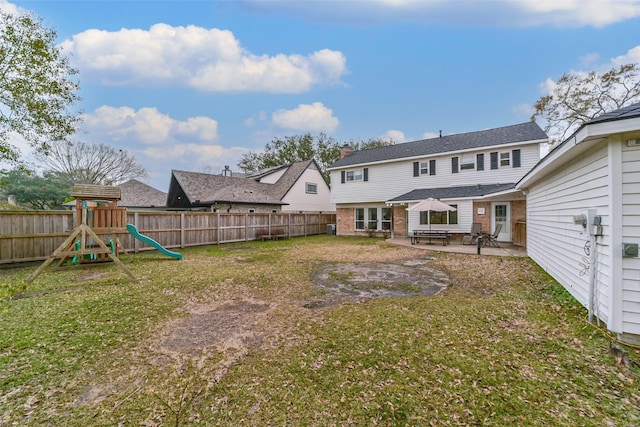 view of yard featuring a playground, a patio area, and a fenced backyard