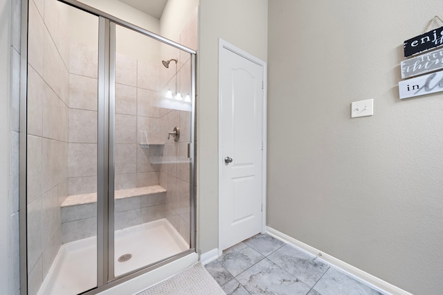 bathroom with an enclosed shower and tile patterned floors