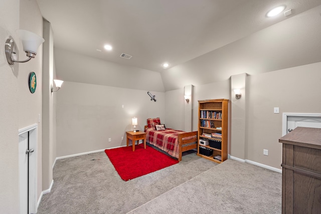 bedroom with vaulted ceiling and light carpet