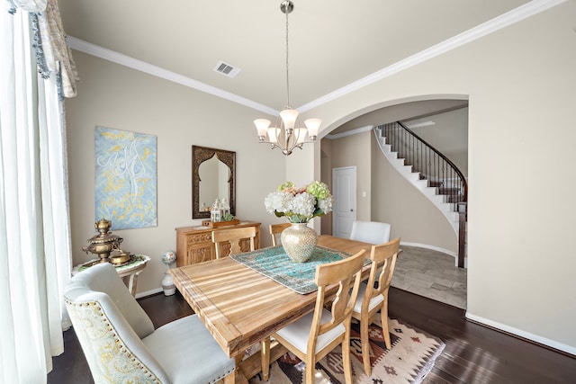 dining room featuring ornamental molding, dark hardwood / wood-style floors, and a notable chandelier