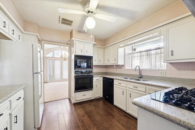 kitchen with sink, white cabinetry, dark hardwood / wood-style floors, decorative backsplash, and black appliances