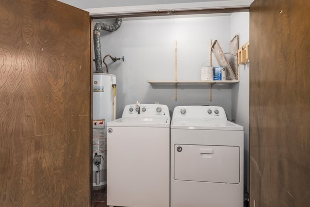 washroom featuring laundry area, water heater, and washer and dryer