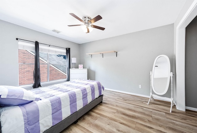 bedroom with ceiling fan and light hardwood / wood-style flooring