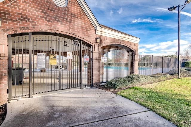 view of gate with a community pool