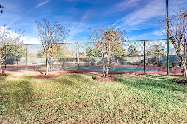 view of sport court featuring a lawn