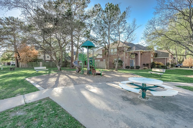 view of playground with a lawn