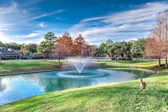 view of home's community featuring a yard and a water view