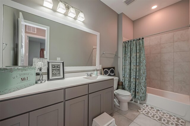 full bathroom featuring shower / bathtub combination with curtain, vanity, tile patterned floors, and toilet