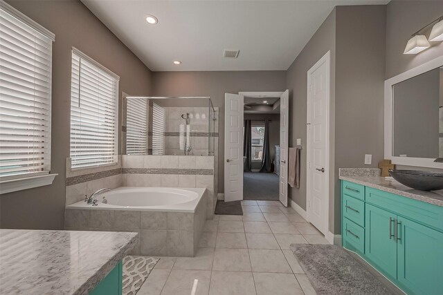 bathroom with tile patterned floors, independent shower and bath, and vanity