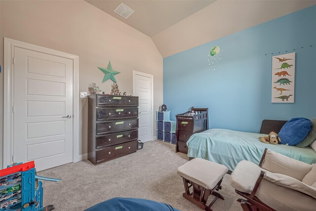 bedroom featuring lofted ceiling and light carpet