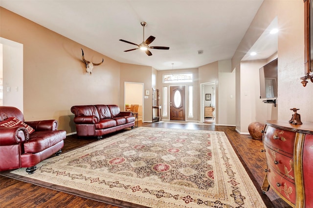 living room featuring ceiling fan and dark hardwood / wood-style flooring